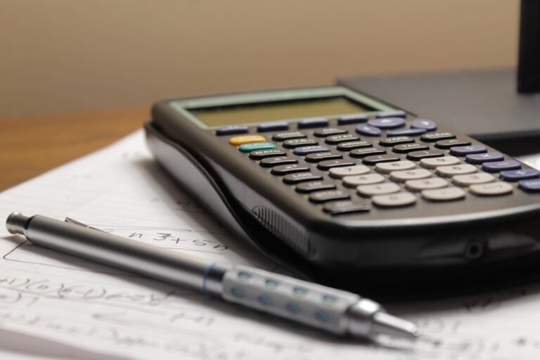 Calculator and pen on handwritten study notes, representing Indian Economy preparation for UPSC.