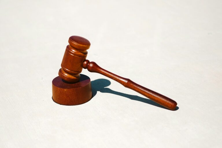 Wooden judicial gavel on white surface representing UPSC Mains essay topic Customary morality cannot be a guide to modern life