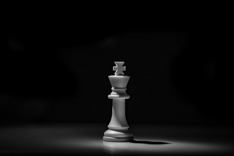 Chess king piece standing alone in dramatic light — UPSC Mains essay topic to test character give a man power