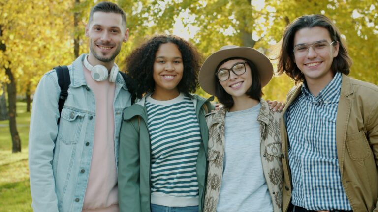 UPSC Mains essay topic A Smile Is the Chosen Vehicle for All Ambiguities — four friends smiling together