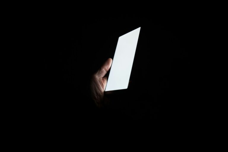 Person holding a smartphone at night — UPSC Mains essay topic Social media is inherently a selfish medium