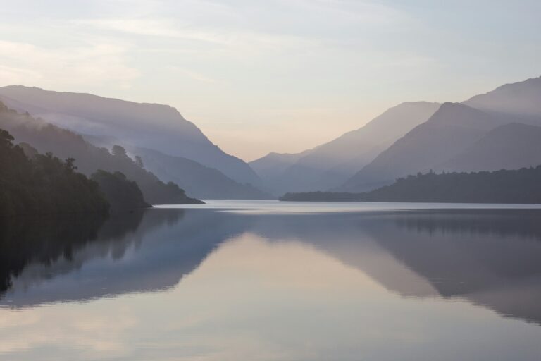 UPSC Mains essay topic Silence is the loudest answer to noise — still mountain lake at dawn. Photo by Neil Mark Thomas on Unsplash.