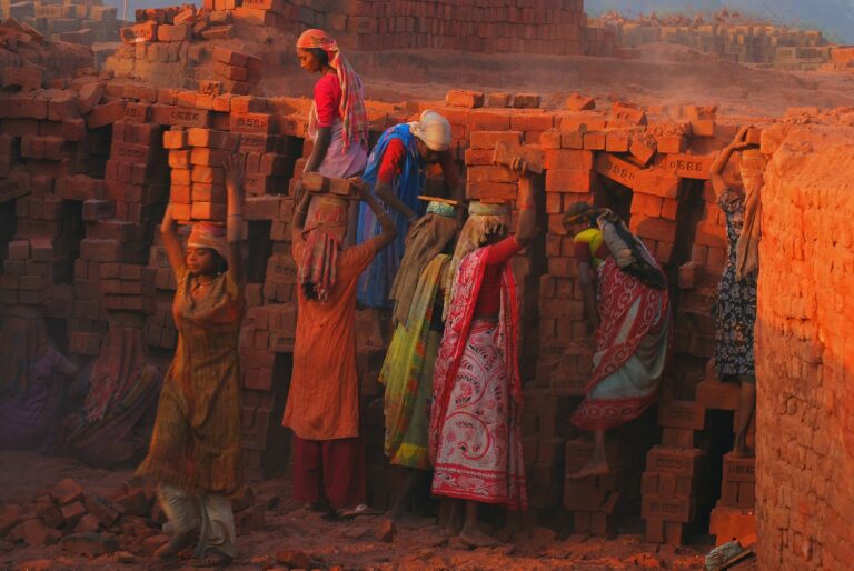 Women working at a brick kiln in India — visual essay anchor for UPSC Mains essay topic on social justice and economic prosperity