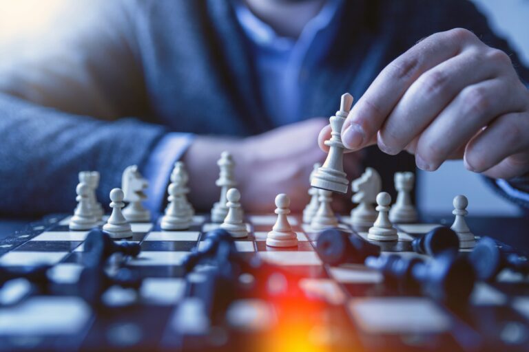 Chess player making a thoughtful move, illustrating UPSC Mains essay topic Visionary decision-making happens at the intersection of intuition and logic.