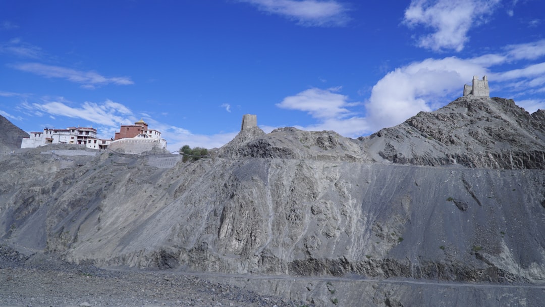 A large open-cast coal mine with terraced benches and haul trucks at work