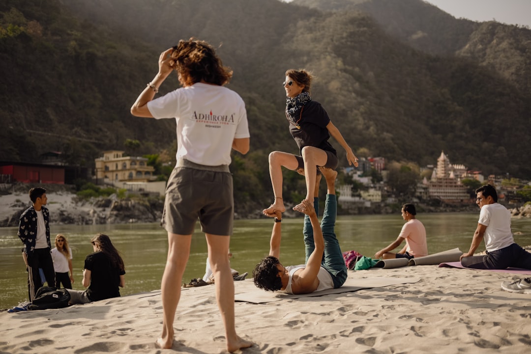 Large group performing yoga asanas together at an outdoor mass session