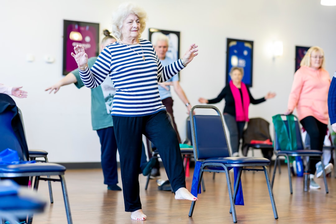 Older adults dancing and exercising together in a community hall