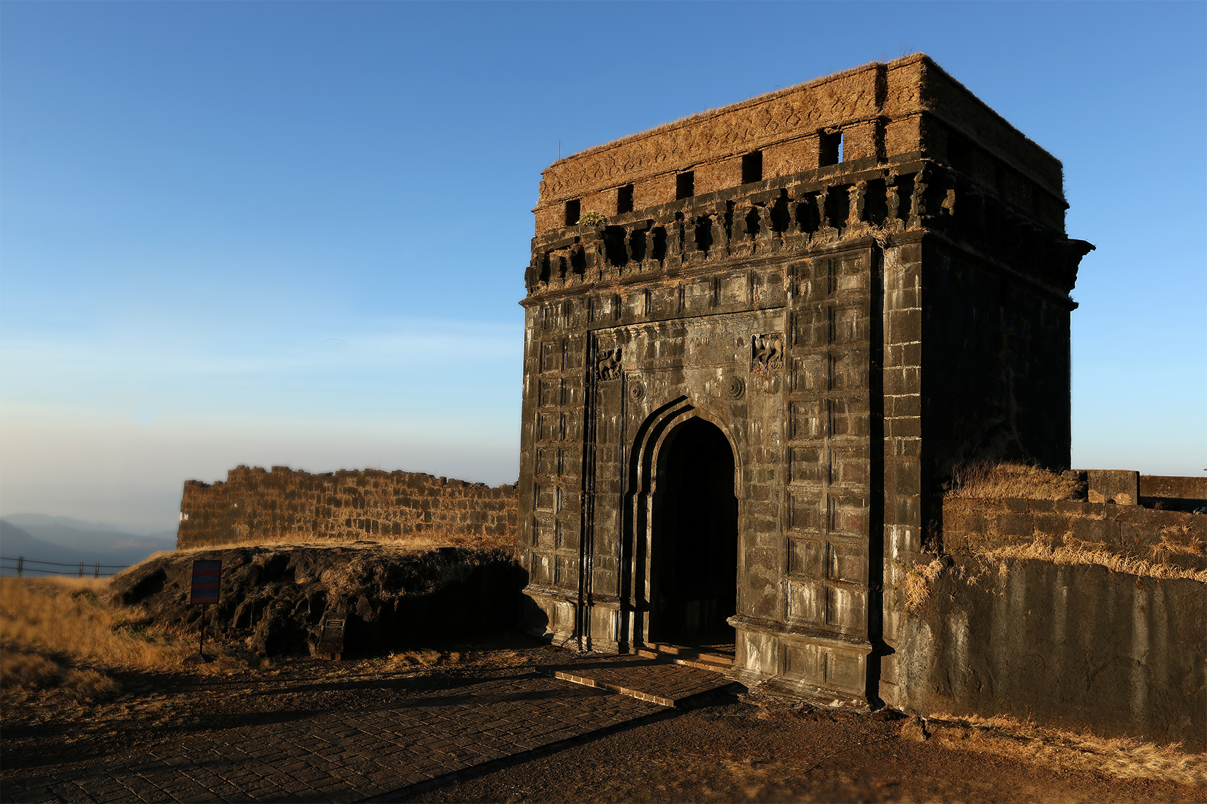 Stone ramparts and gateway of Raigad Fort on a hilltop in the Western Ghats