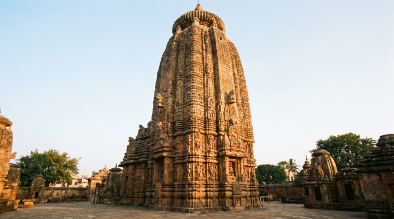 The carved Kalinga-style sandstone tower of the Lingaraja Temple in golden light