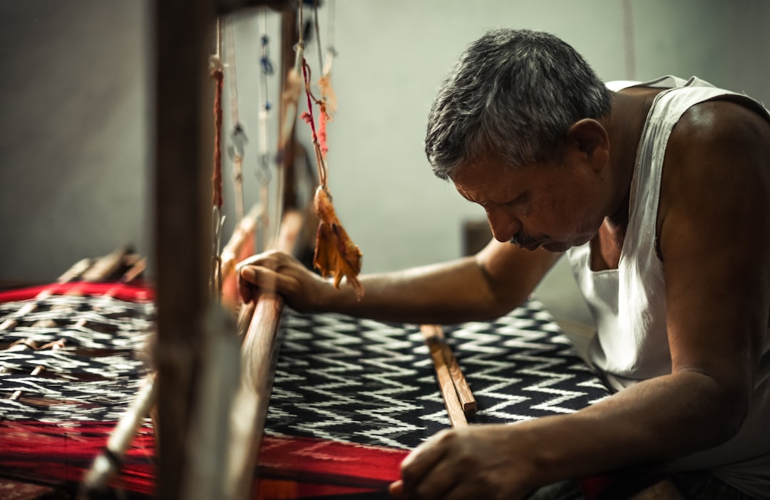 Indian artisan working on traditional handicraft at a craft stall