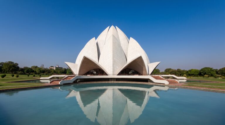 The white marble petals of the Lotus Temple in New Delhi against a blue sky