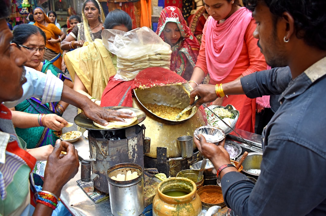 An Indian street food vendor preparing food at a busy market stall