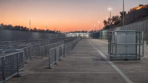 Separated queue lanes, protected electrical equipment and an emergency access route illustrate crowd-safety planning.