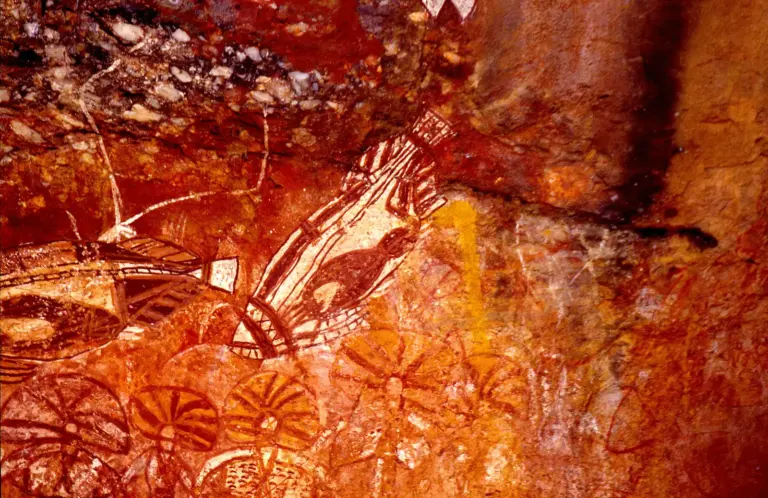 Ochre figures painted on the wall of a rock shelter