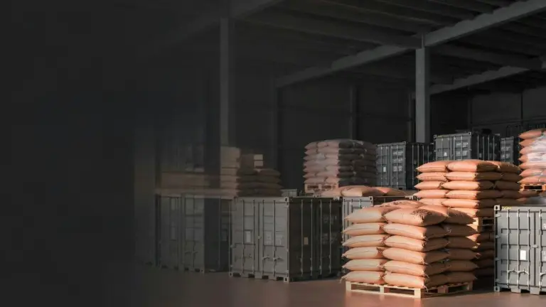 Stacked grain sacks filling a procurement warehouse