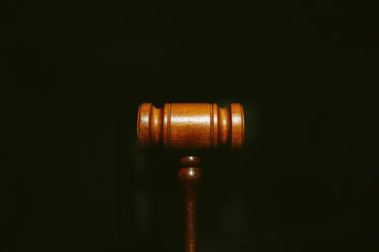 A judge's bench and gavel in an empty courtroom