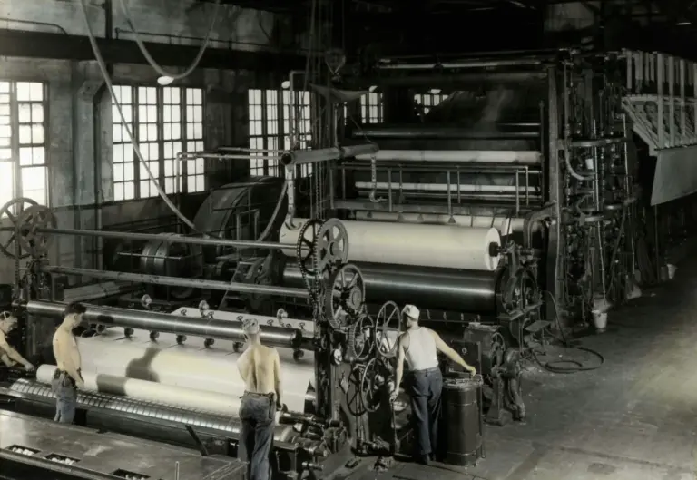 Heavy machinery inside an older industrial workshop