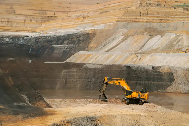An excavator working the benches of an opencast mine