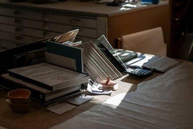 A civil servant's desk stacked with case files