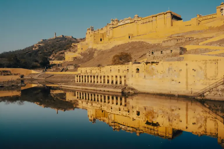 Amer Fort's sandstone palace walls and ramparts rising above Maota Lake on a hill near Jaipur