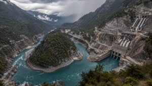 Hydropower construction beside the Great Bend of a Himalayan river in steep mountain terrain