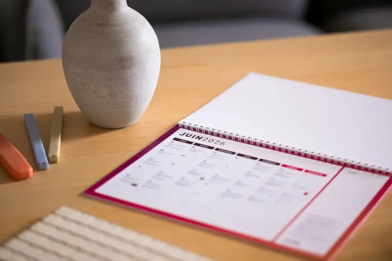Calendar and vase on a wooden desk