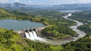 Illustrative two reservoir dams and connecting river valley in green hilly terrain