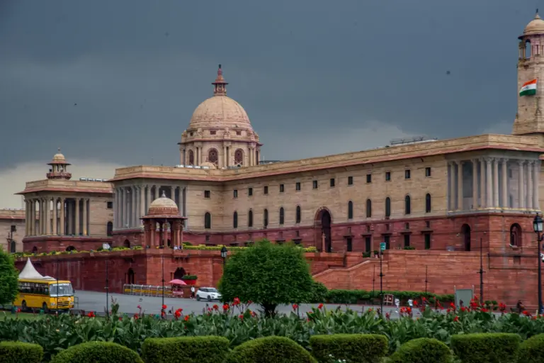 Sandstone government building with columns and a dome
