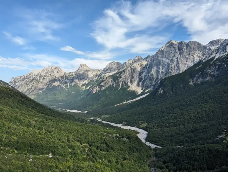 A river winding through a glaciated mountain valley. Photo by Sebastian Kohlhauer on Unsplash via Unsplash.