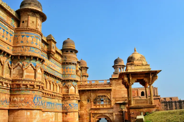 Man Mandir palace on Gwalior Fort, its sandstone wall banded with blue, green and yellow tiles between round towers