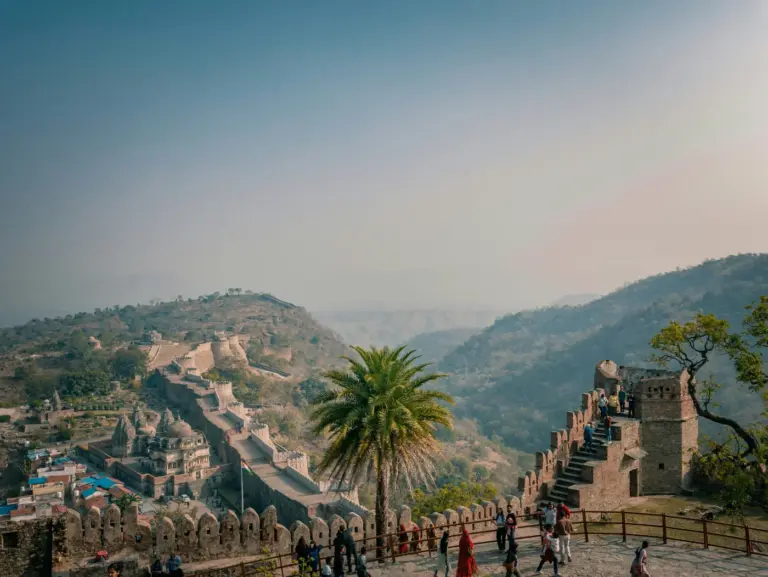 Kumbhalgarh Fort's long crenellated wall running over forested Aravalli ridges in Rajasthan