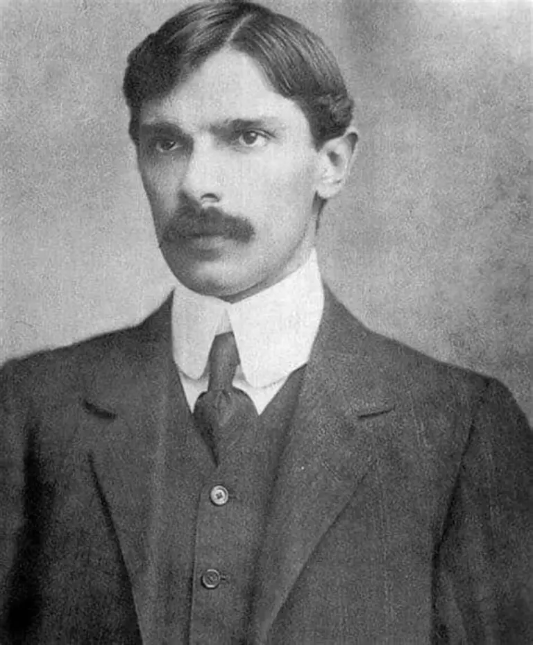 Circa-1910 studio portrait of barrister Muhammad Ali Jinnah in a dark three-piece suit and high white collar