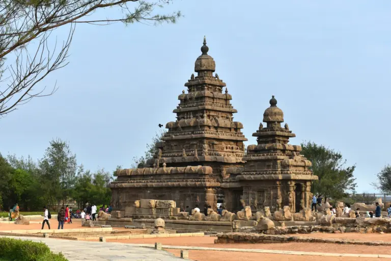 The 8th-century Shore Temple at Mahabalipuram, its two carved granite towers against a clear blue sky