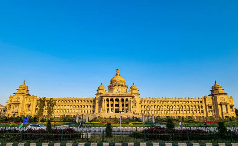 Vidhana Soudha, Karnataka's legislature building in Bengaluru, its domed stone facade under a clear blue sky