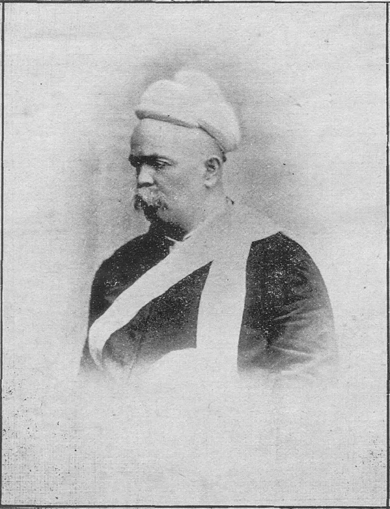 Black-and-white portrait of Justice Mahadev Govind Ranade in a white turban, dark coat and white sash