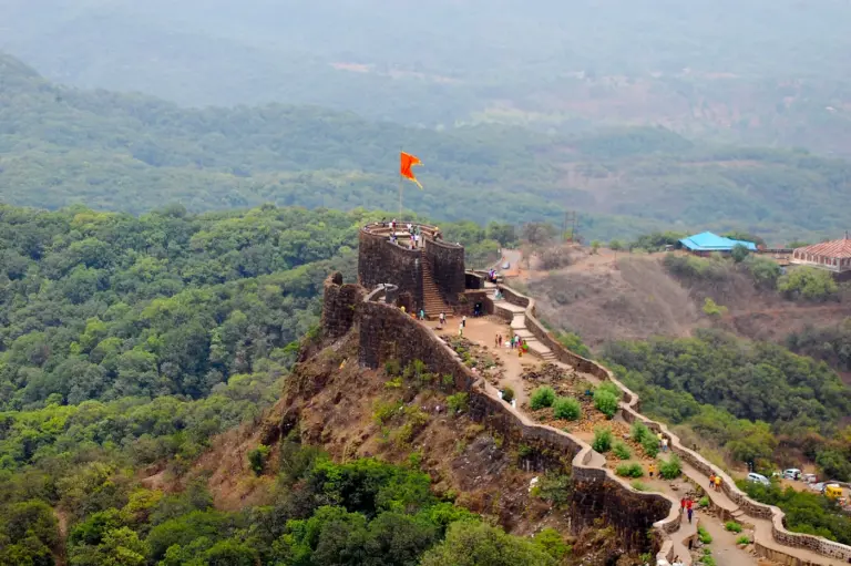 Stone ramparts and bastions of Pratapgad Fort on a forested spur of the Sahyadri hills near Mahabaleshwar