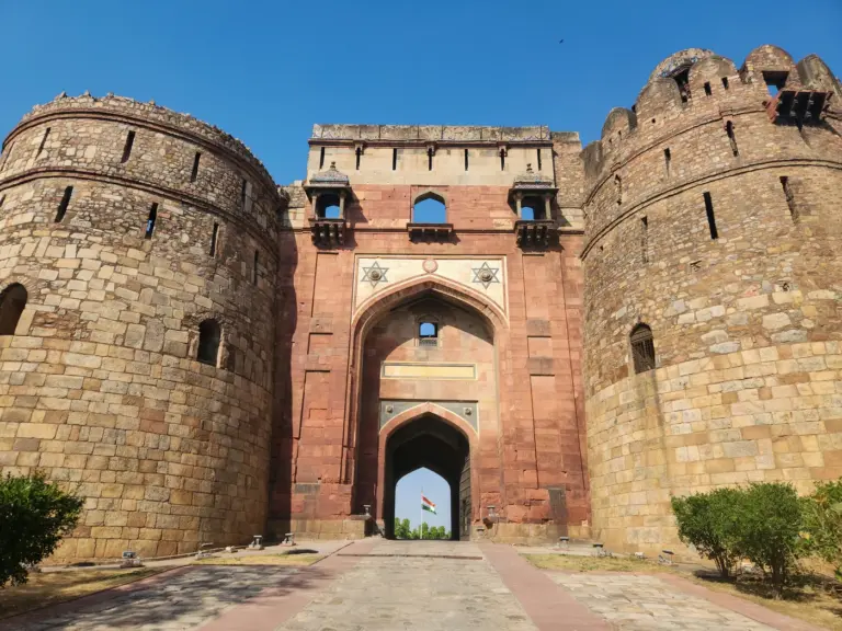 Red sandstone gateway and bastions of Purana Qila, the Old Fort in Delhi, with chhatris on the ramparts