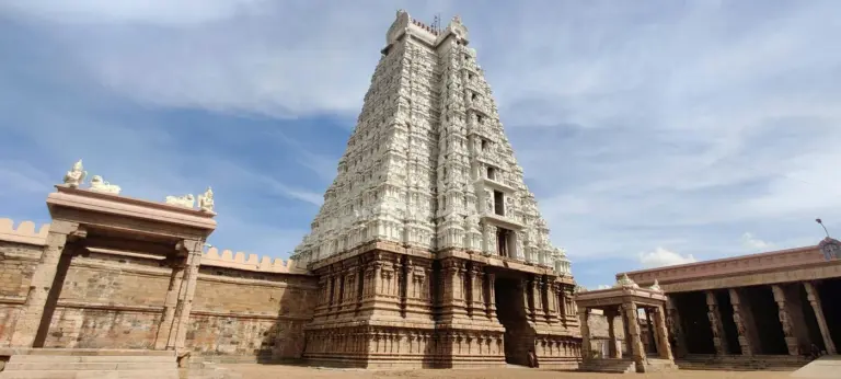 A white gopuram of the Sri Ranganathaswamy temple at Srirangam, Tamil Nadu, under a cloudy sky