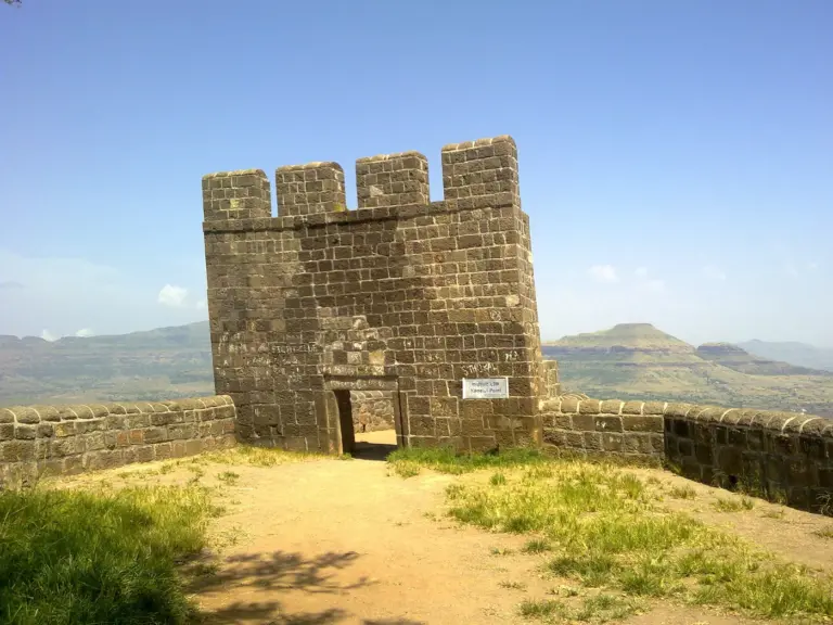 The long flat-topped scarp of Shivneri Fort rising above farmland near Junnar in Pune district, Maharashtra