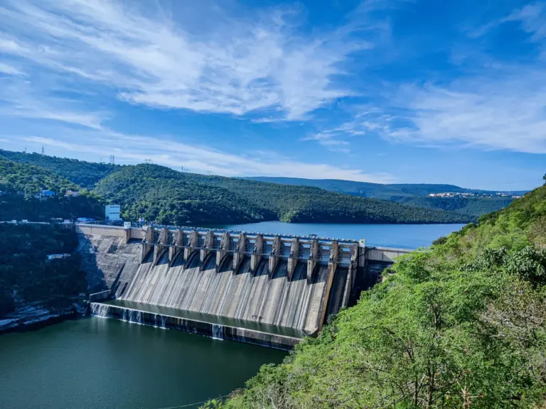 Srisailam Dam's concrete spillway across the Krishna river, with its reservoir winding between forested hills