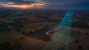 Satellite-style observation of crop-residue burning across agricultural fields at dusk