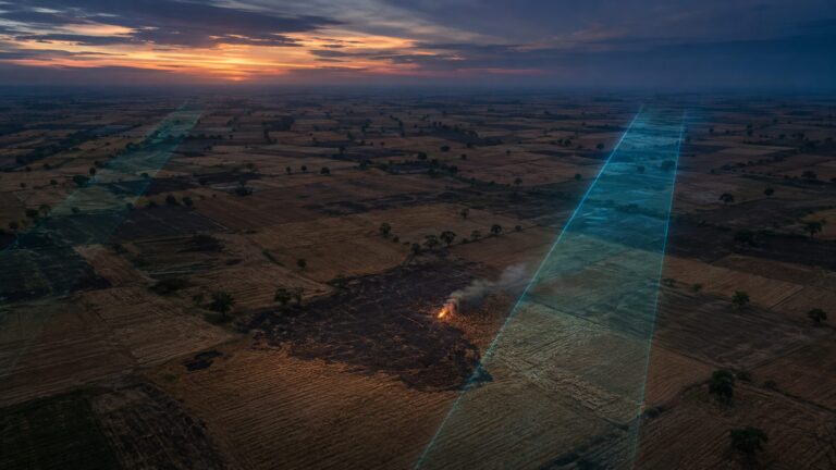 Satellite-style observation of crop-residue burning across agricultural fields at dusk