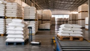 Sugar sacks arranged in regulated inventory lots inside a wholesale warehouse