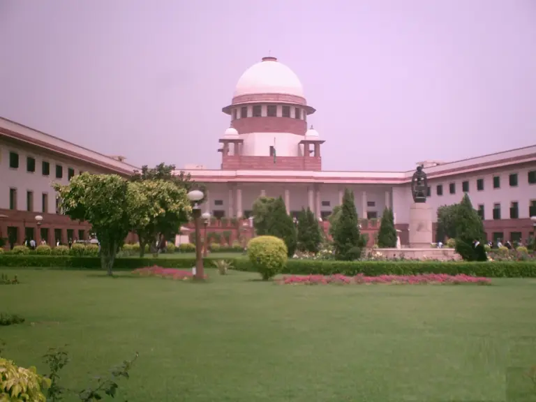 The domed main building of the Supreme Court of India in New Delhi seen from its front lawns.
