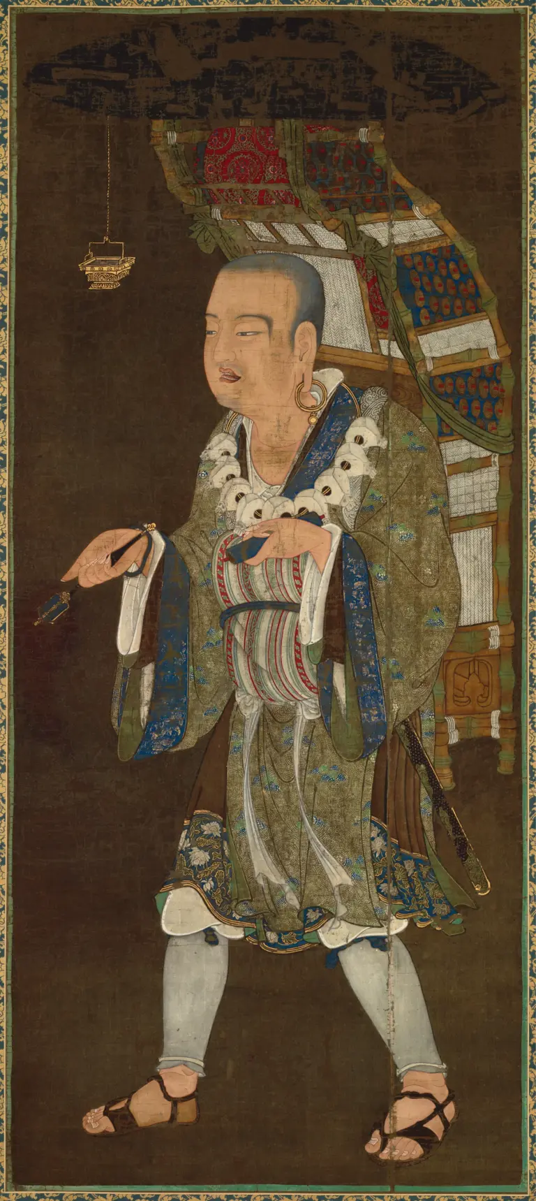 A 14th-century Japanese silk painting of the Chinese pilgrim Xuanzang on his journey to India, carrying a pack frame.