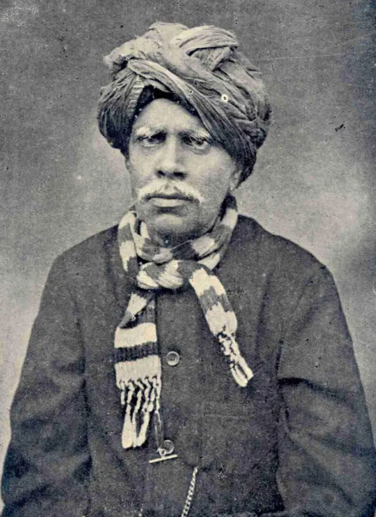 Portrait photograph of Kandukuri Veeresalingam in a turban and striped scarf, from a 1916 Telugu library journal.