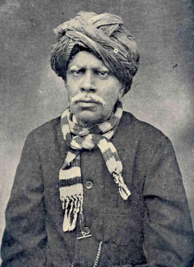 Portrait photograph of Kandukuri Veeresalingam in a turban and striped scarf, from a 1916 Telugu library journal.
