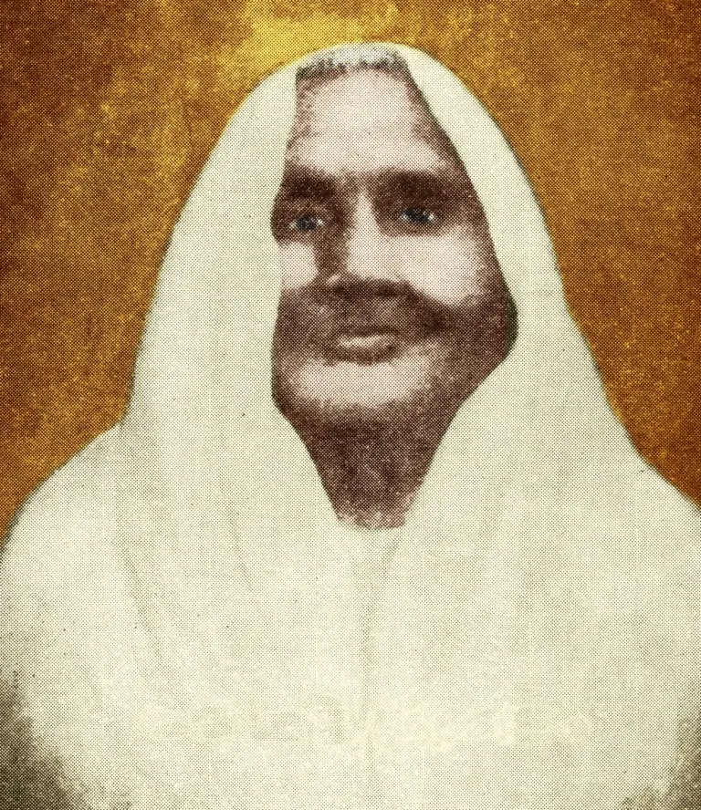 Portrait of Matangini Hazra wearing a white sari drawn over her head.