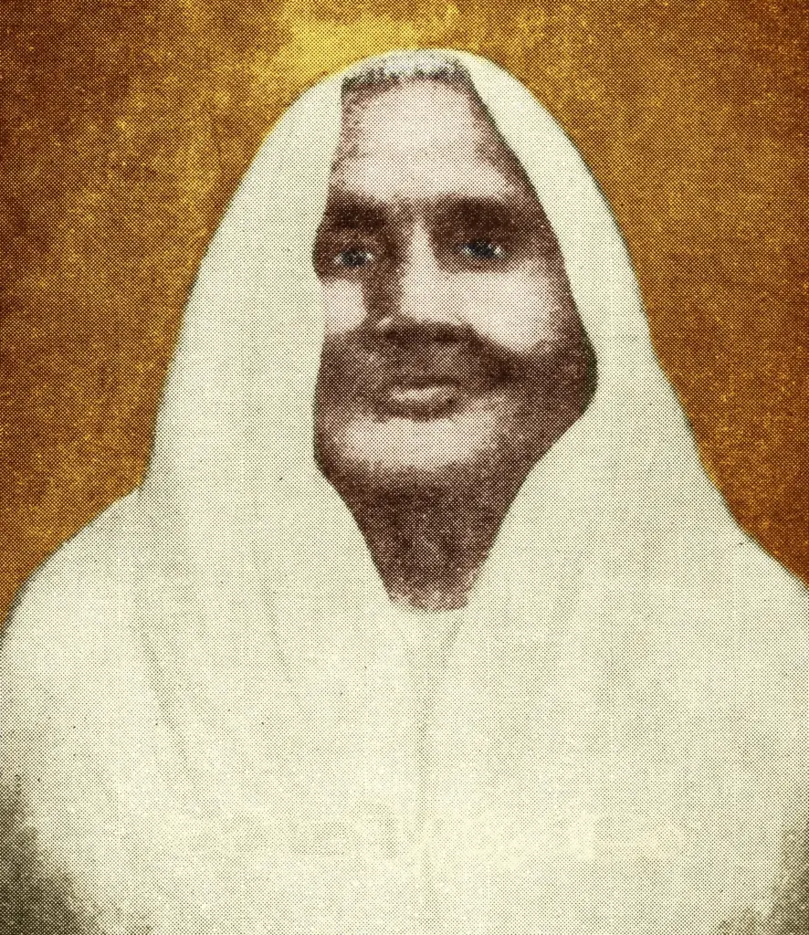 Portrait of Matangini Hazra wearing a white sari drawn over her head.
