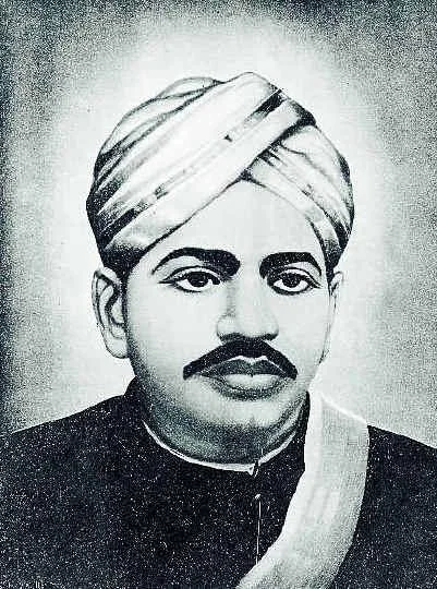 Black and white portrait of V. O. Chidambaram Pillai wearing a turban and a sash.